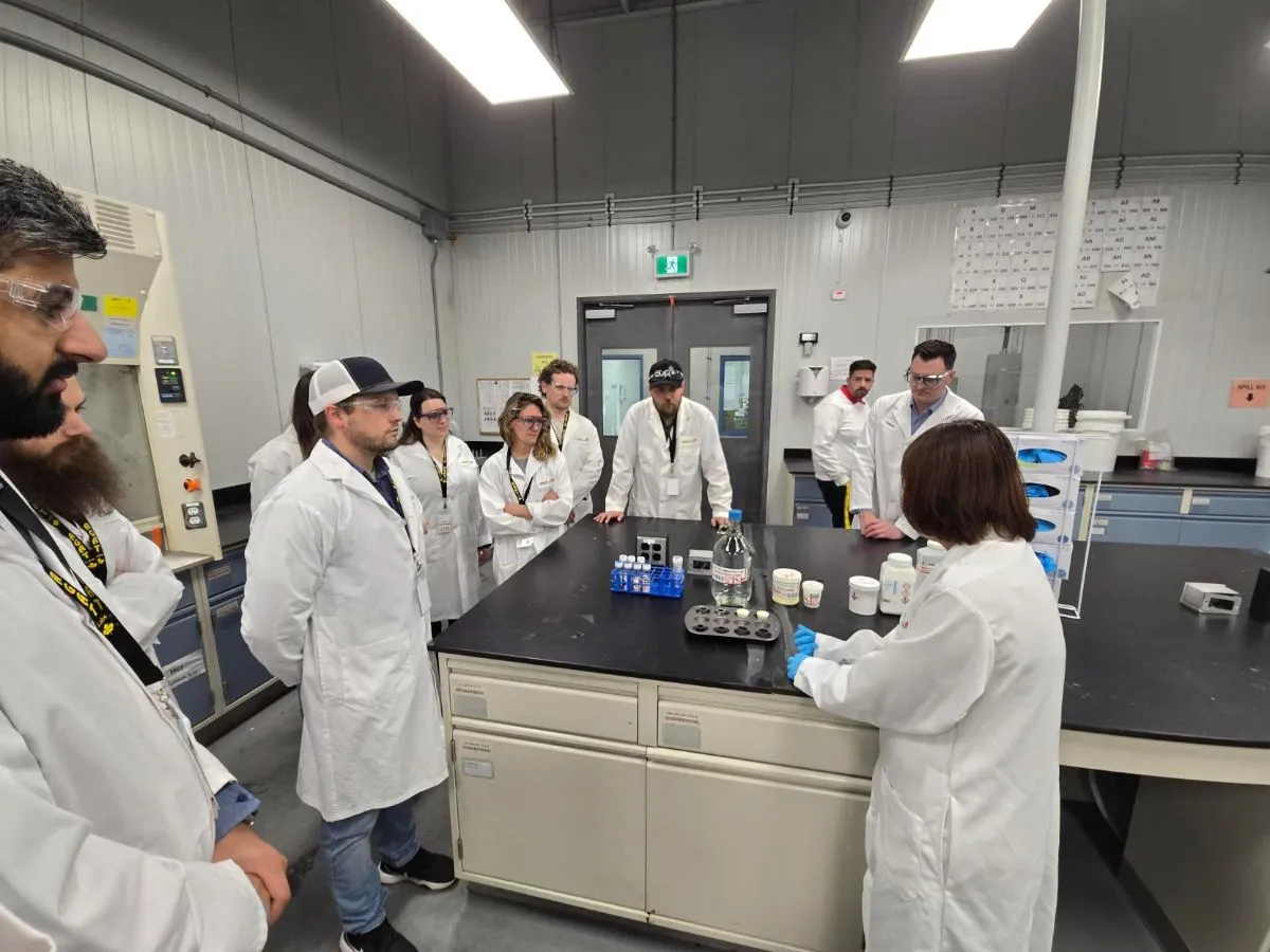 Team touring an AGAT laboratory in lab coats
