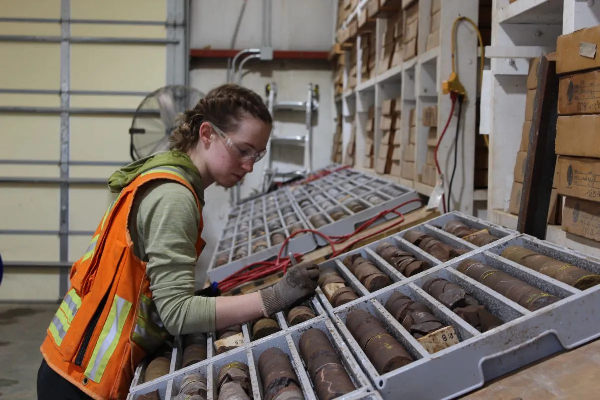 Geologist logging core trays in a warehouse
