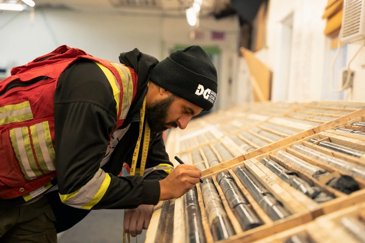 Geologist marking drill core in the Cisco core shack