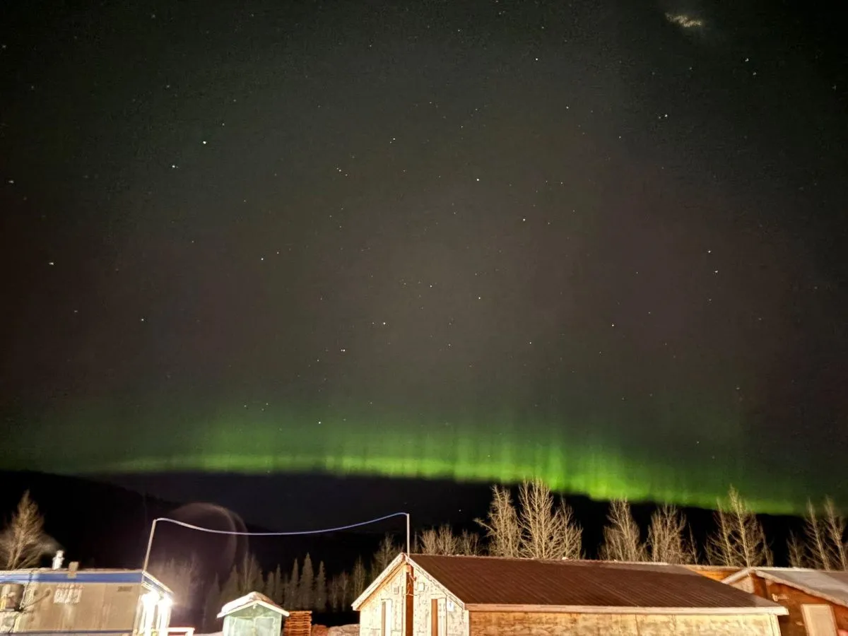 Northern lights over camp buildings