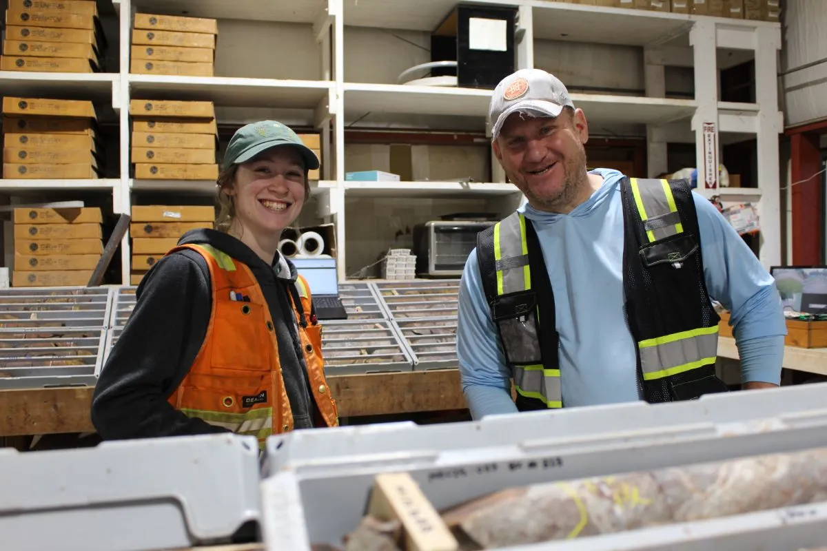 Two geologists at a core logging bench