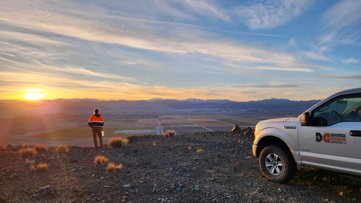 Geologist at sunrise beside a Dahrouge truck at Pumpkin Hollow