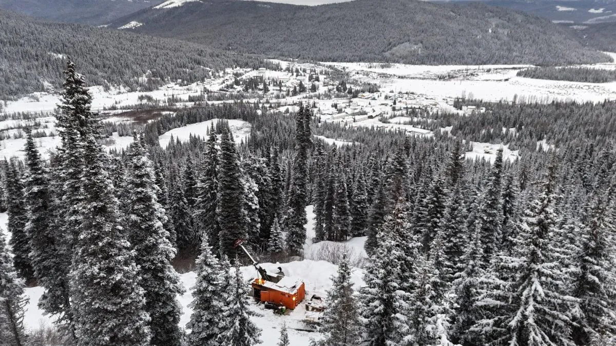 Snow-covered forest and drill site in the mountains